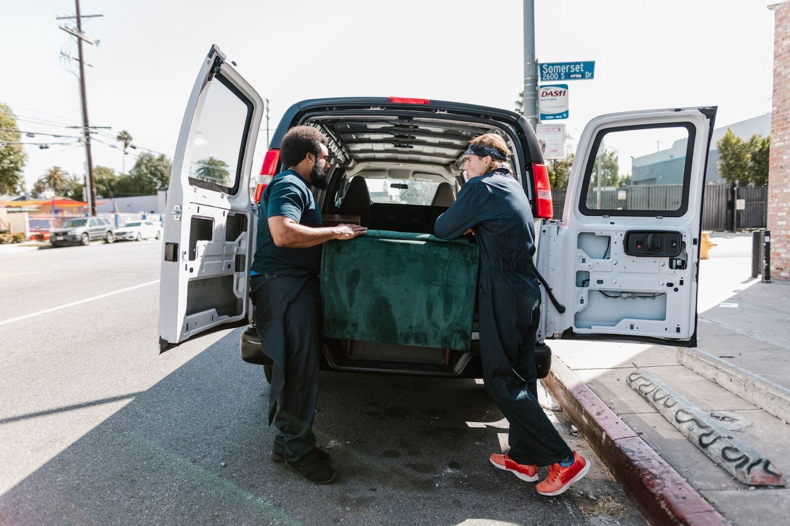 Crew loading an old couch into the truck during a junk removal pickup in Orange County, CA